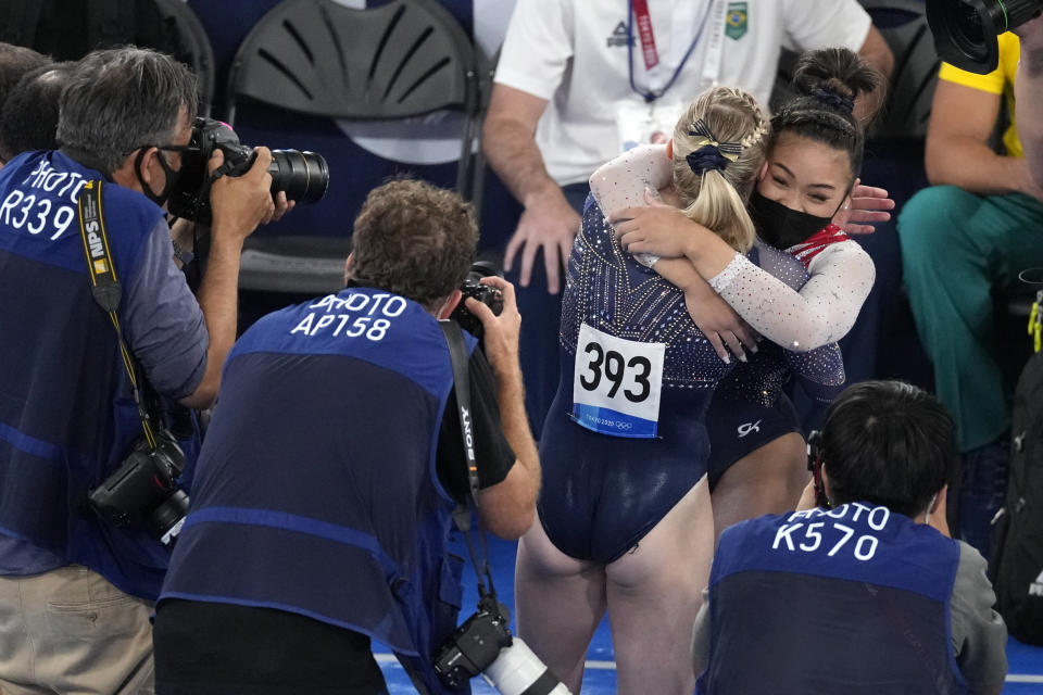 Sunisa Lee, of the United States, embraces teammate Jade Carey after winning the gold medal in the artistic gymnastics women's all-around final at the 2020 Summer Olympics, Thursday, July 29, 2021, in Tokyo. (AP Photo/Ashley Landis)