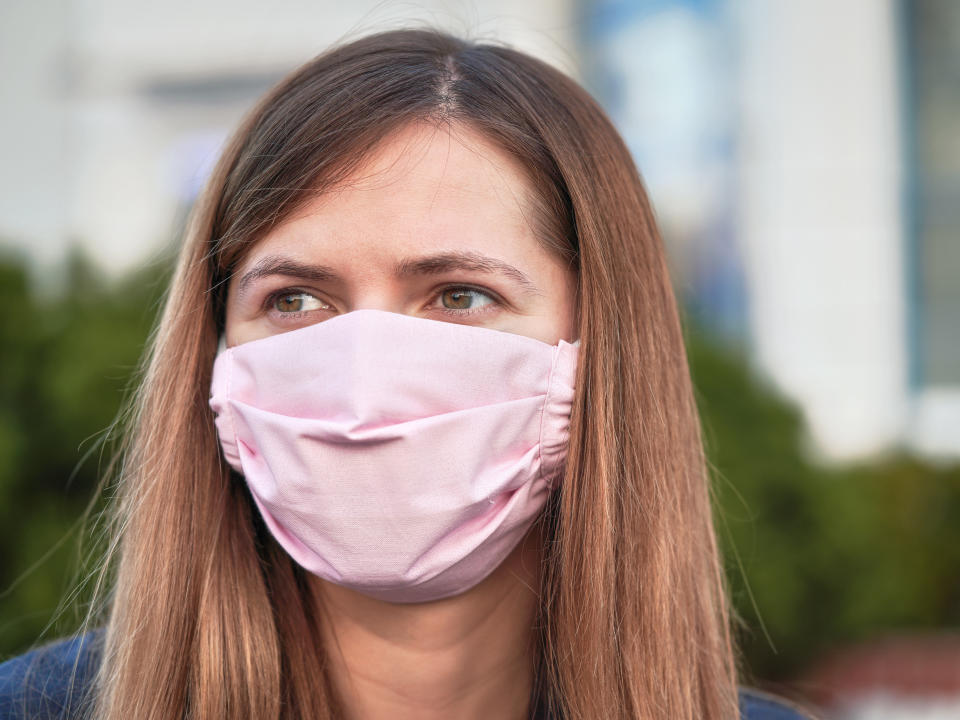 Young woman with hand made face nose mouth mask portrait, can be used during coronavirus covid19 outbreak prevention