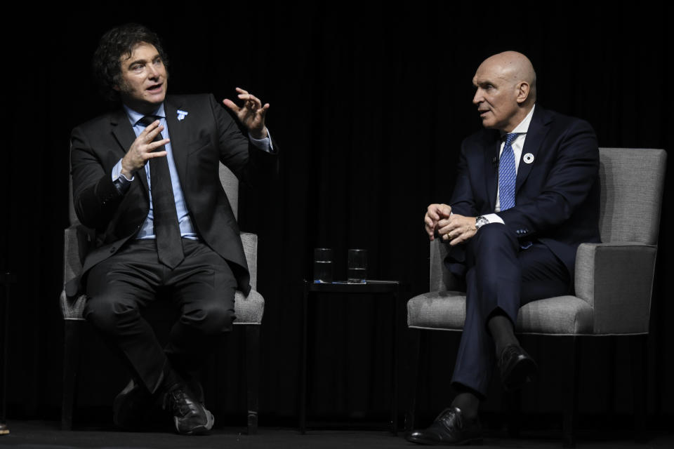 Argentine President Javier Milei, left, addresses the crowd at a promotional event for his new book, alongside National Deputy Jose Luis Espert in Buenos Aires, Argentina, Wednesday, May 22, 2024. (AP Photo/Gustavo Garello)