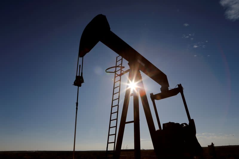 FILE PHOTO: FILE PHOTO: The sun is seen behind a crude oil pump jack in the Permian Basin in Loving County