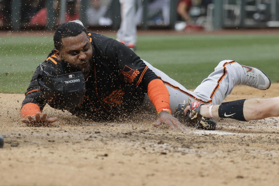 San Francisco Giants' Pablo Sandoval slides safe into home ahead of the tag from Arizona Diamondbacks' John Hicks during the fifth inning of a spring training baseball game, Monday, March 2, 2020, in Scottsdale, Ariz.(AP Photo/Darron Cummings)