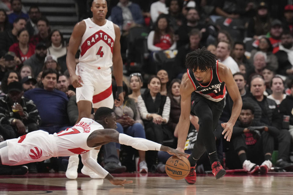Toronto Raptors guard Dennis Schroder (17) and Portland Trail Blazers guard Shaedon Sharpe (17) battle for the ball during second-half NBA basketball game action in Toronto, Monday, Oct. 30, 2023. (Nathan Denette/The Canadian Press via AP)