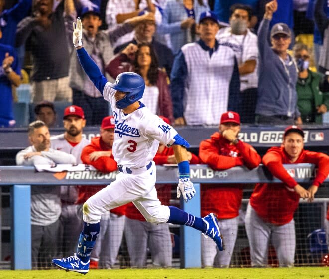 LOS ANGELES, CA - OCTOBER 6, 2021: Los Angeles Dodgers left fielder Chris Taylor (3) runs past a dejected St Louis Cardinals bench after hitting a 2-run homer to win the National League Wild Card game at Dodger Stadium on October 6, 2021 in Los Angeles, California.(Gina Ferazzi / Los Angeles Times)