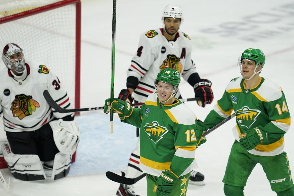 Minnesota Wild left wing Matt Boldy (12) celebrates next to center Joel Eriksson Ek (14) after scoring during the second period of an NHL hockey game against the Chicago Blackhawks, Sunday, Dec. 3, 2023, in St. Paul, Minn. (AP Photo/Abbie Parr)