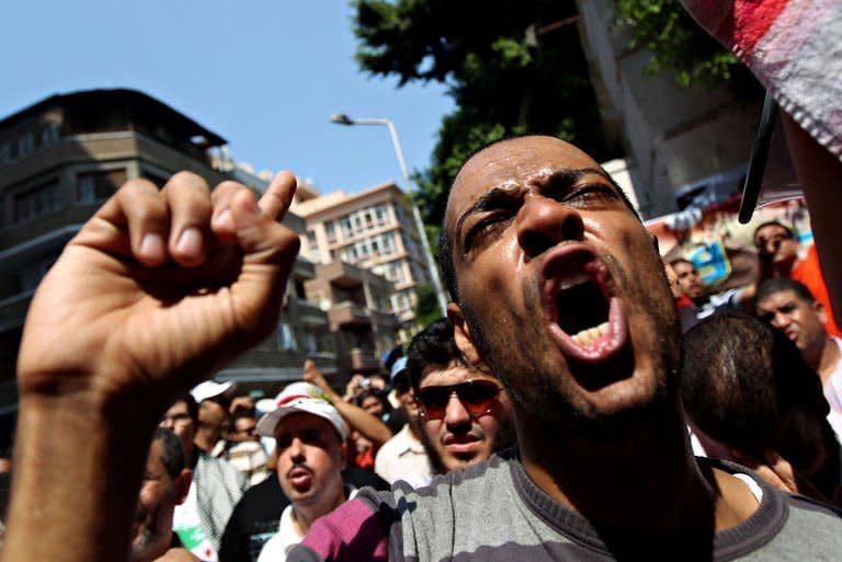 A protester shouts slogans against President Bashar al-Assad during a demonstration outside Syria's embassy in Cairo. The US, French and German leaders pledged to consider new steps to punish Syria after security forces shot dead at least 22 people as tens of thousands staged anti-regime protests on the first Friday of Ramadan