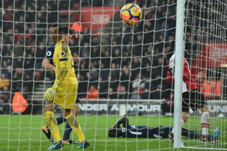 Tottenham Hotspur's defender Davinson Sanchez (C) reacts after deflecting the ball into his own net past goalkeeper Michel Vorm (L) on January 21, 2018