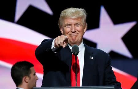 Republican presidential nominee Donald Trump points at the gathered media during his walk through at the Republican National Convention in Cleveland, U.S., July 21, 2016. REUTERS/Rick Wilking