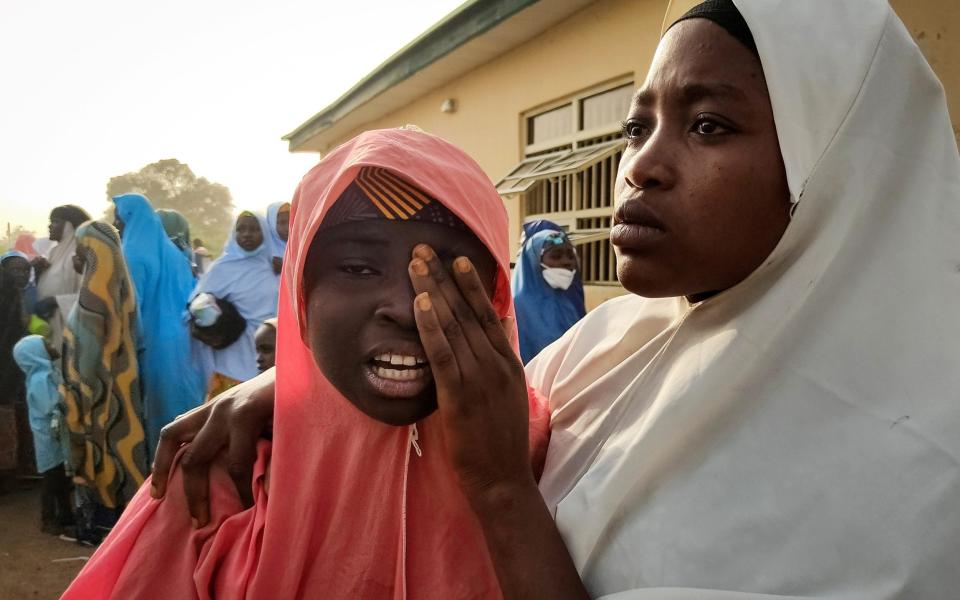 A kidnapped girl reacts as she reunites with a family member in Jangebe, Zamfara state, on March 3, 2021 - AMINU ABUBAKAR /AFP