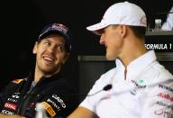 SAO PAULO, BRAZIL - NOVEMBER 22: Sebastian Vettel (L) of Germany and Red Bull Racing shares a joke with Michael Schumacher (R) of Germany and Mercedes GP while attending the drivers press conference during previews for the Brazilian Formula One Grand Prix at the Autodromo Jose Carlos Pace on November 22, 2012 in Sao Paulo, Brazil. (Photo by Clive Mason/Getty Images)