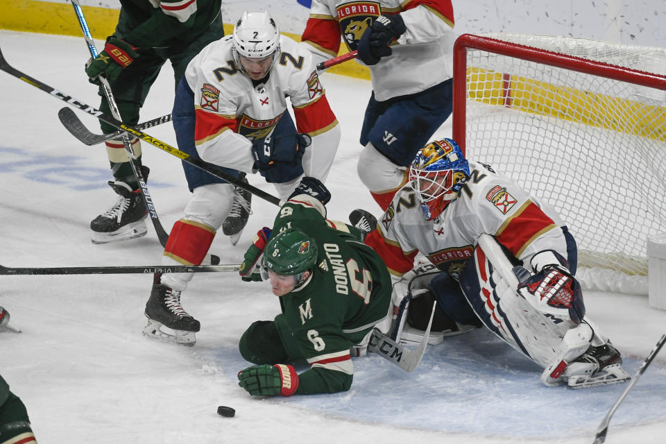 Florida Panthers defenseman Josh Brown (2) collided with Minnesota Wild center Ryan Donato in front of Panthers goalie Sergei Bobrovsky during the first period of an NHL hockey game Monday, Jan. 20, 2020, in St. Paul, Minn. (AP Photo/Craig Lassig)