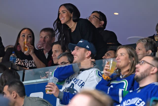 <p>Derek Cain/Getty</p> Meghan Markle watches the NHL game between the Vancouver Canucks and San Jose Sharks at Rogers Arena on November 20.