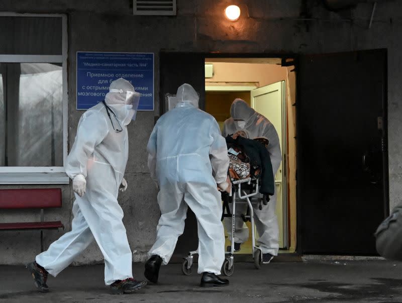 FILE PHOTO: Paramedics transport a patient to a amid the coronavirus disease outbreak in Omsk