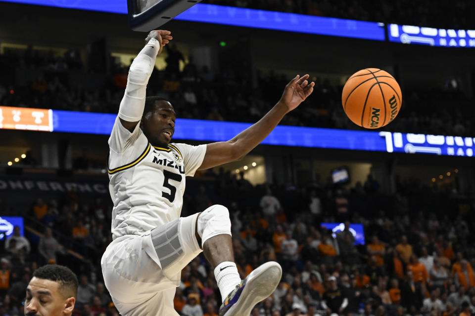 Missouri guard D'Moi Hodge comes down from a dunk against Tennessee during the second half of an NCAA college basketball game in the quarterfinals of the Southeastern Conference Tournament, Friday, March 10, 2023, in Nashville, Tenn. (AP Photo/John Amis)