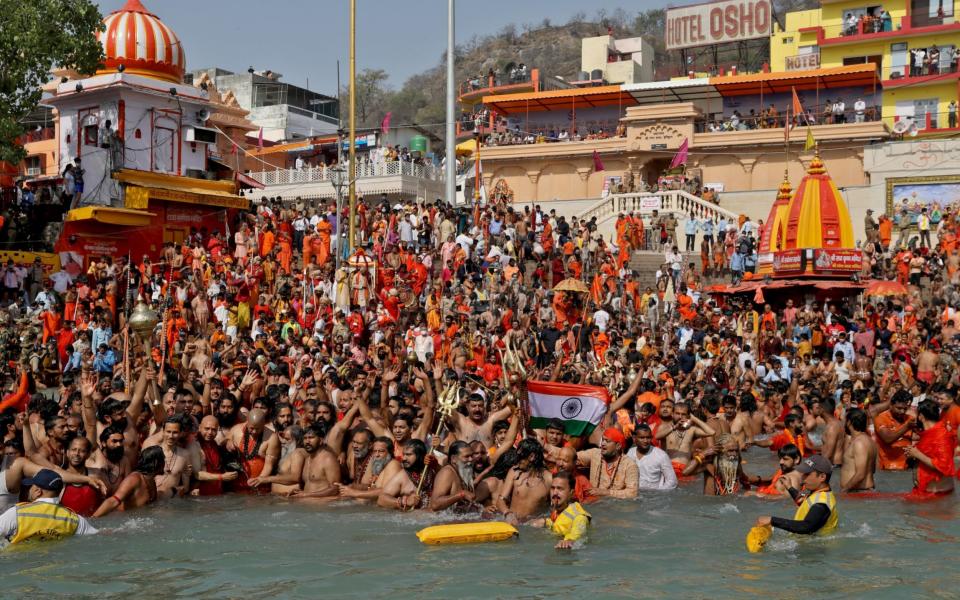 Hindu devotees take a holy dip in the Ganges River during Shahi Snan at "Kumbh Mela", or the Pitcher Festival, amidst the spread of the coronavirus disease  - REUTERS/Anushree Fadnavis