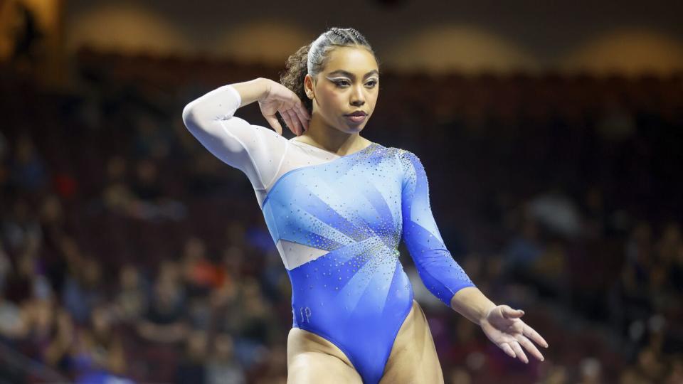 UCLA gymnast Margzetta Frazier places one arm behind her neck and the other to the front during a routine