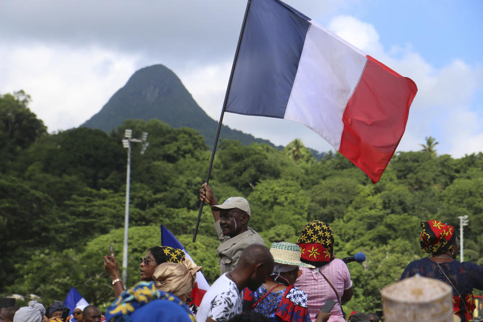 Supporters of the so-called Wuambushu operation that aims at expelling migrants, gather at a soccer stadium in Chirongui, in the French Indian Ocean territory of Mayotte, Thursday, April 27, 2023. France is facing a migration quagmire on the island territory of Mayotte off Africa’s east coast. The government sent in 2,000 troops and police to carry out mass expulsions, destroy slums and eradicate violent gangs. But the operation has become bogged down and raised concerns of abuse, aggravating tensions between local residents and immigrants from the neighboring country of Comoros. (AP Photo/Gregoire Merot)