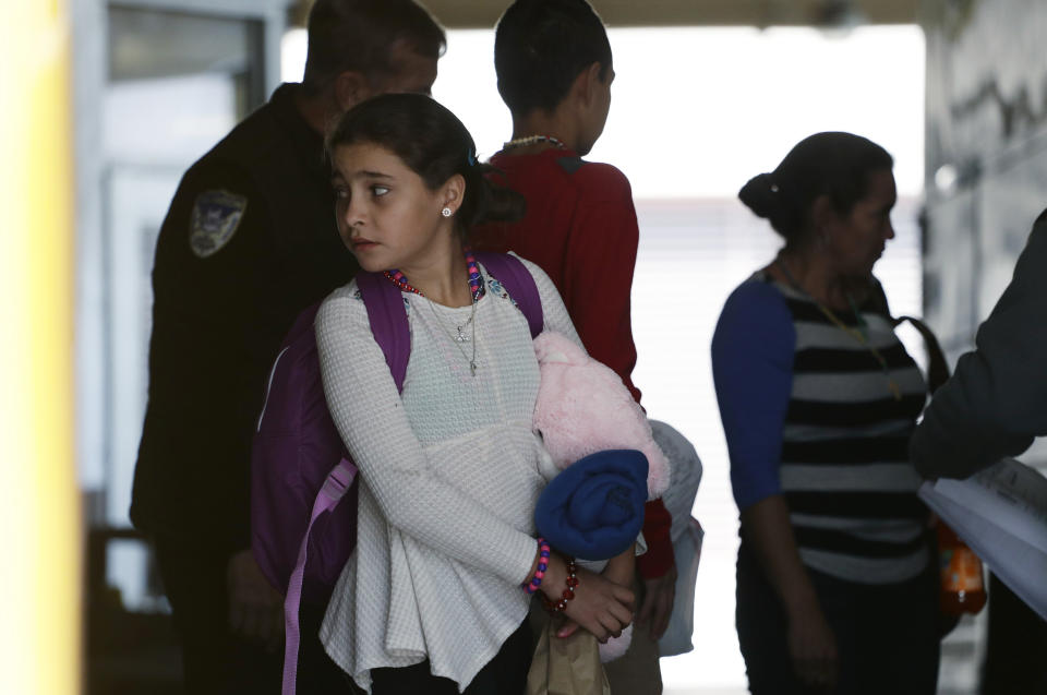 Immigrants from Central America seeking asylum board a bus, Tuesday, April 2, 2019, in downtown San Antonio. The surge of migrants arriving at the southern border has led the Trump administration to dramatically expand a practice it has long mocked as "catch and release." (AP Photo/Eric Gay)