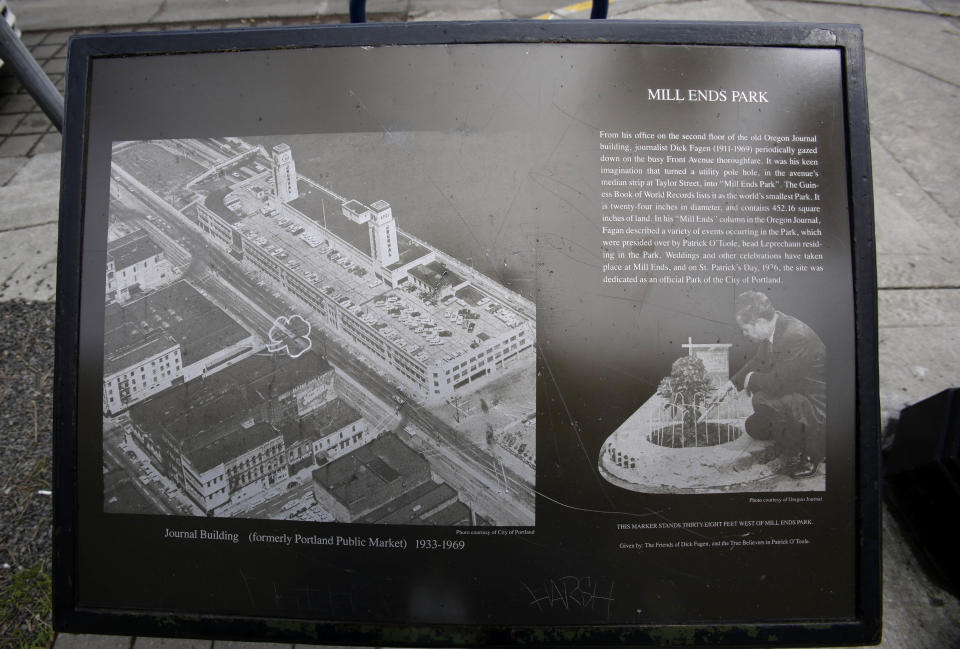 A plaque illustrates the history of Mill Ends Park in Portland, Ore., Thursday, April 11, 2013. Tiny battle lines are being drawn in a whimsical British-American dispute over which country has the world’s smallest park. Two feet in diameter, Portland’s Mill Ends Park holds the title of world’s smallest park in the Guinness Book of World Records. But a rival has emerged--Prince’s Park, more than 5,000 miles away in the English town of Burntwood which holds the record for smallest park in the United Kingdom.(AP Photo/Don Ryan)