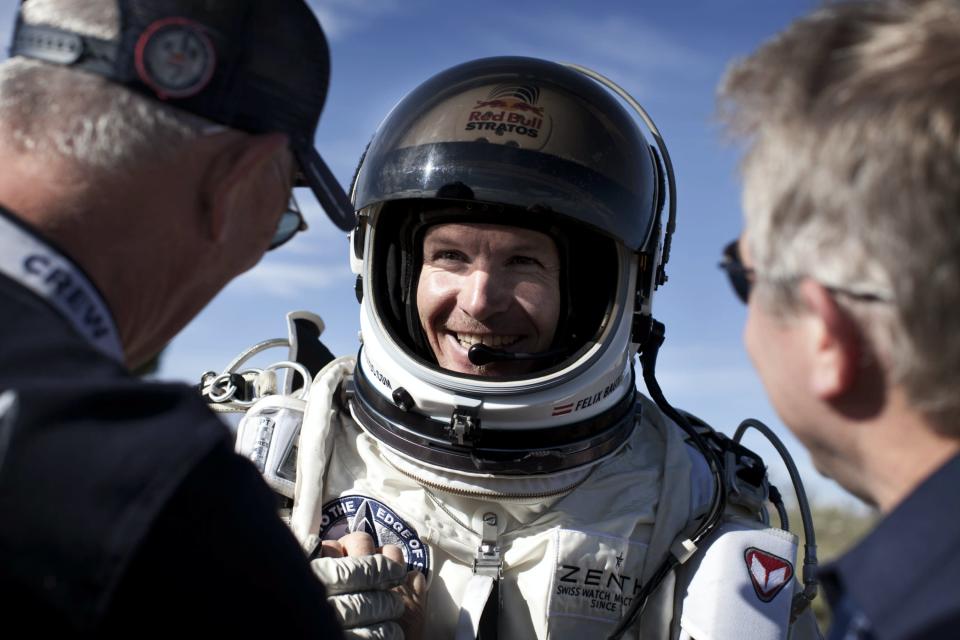 Pilot Felix Baumgartner of Austria celebrates after he lands at the desert during the second manned test flight for Red Bull Stratos in Roswell, New Mexico, USA on July 25, 2012.Â Red Bull Stratos is a mission to the edge of space to an altitude of 37.000 meters to break several records including the sound of speed in freefall. (Photo courtesy Red Bull Stratos)