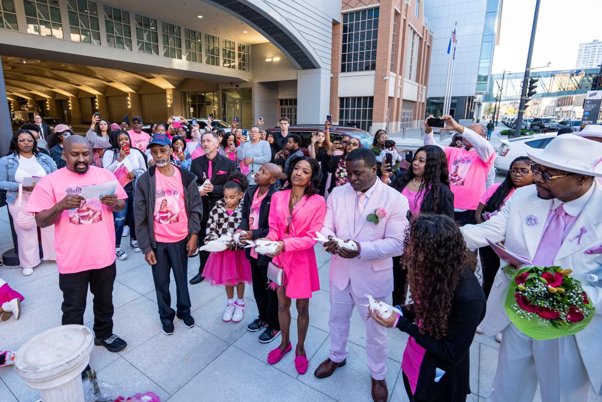 (Center left to right) Sheena Scarbrough, mother of Sade Robinson, Carlos Robinson, father of Sade Robinson, Adrianna Reams, sister of Sade Robinson, prepare to release doves in memory Sade Robinson at her public memorial service on Friday May 10, 2024 at the Baird Center in Milwaukee, Wis.