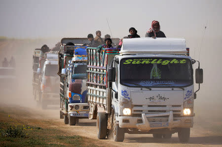 Trucks loaded with civilians ride near the village of Baghouz, Deir Al Zor province, Syria February 22, 2019. REUTERS/Rodi Said