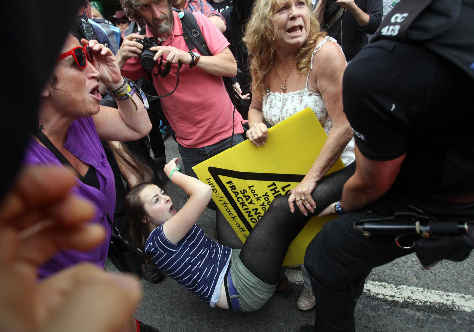 Police tackle a protester at the Balcombe fracking site in West Sussex as energy company Cuadrilla has started testing equipment ahead of exploratory oil drilling in the English countryside as anti-fracking protests at the site entered a ninth day.