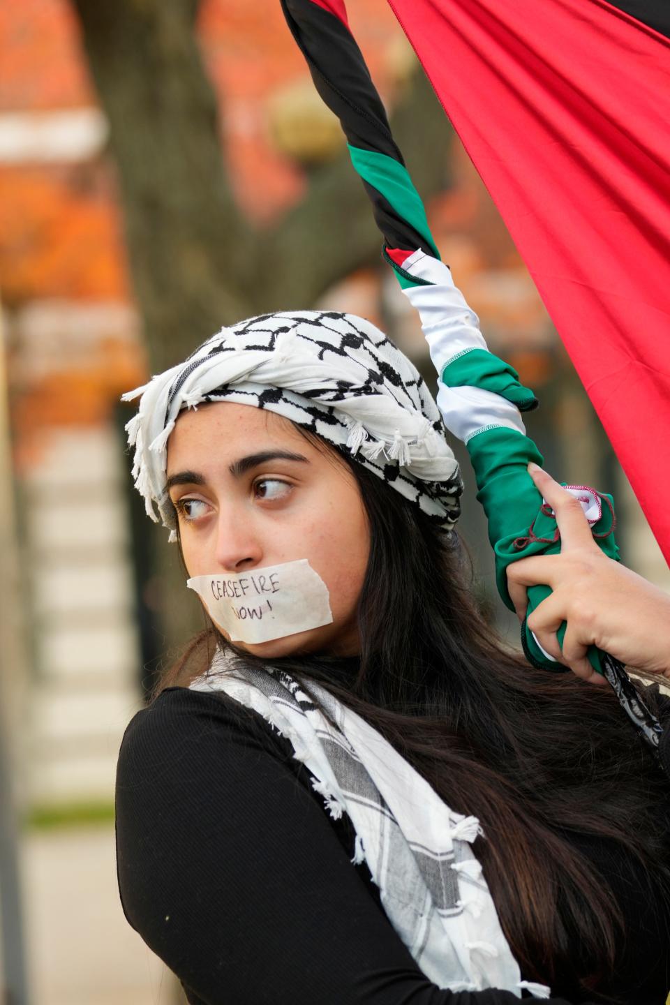 A woman holds a Palestinian flag during the silent rally, in Paterson, Thursday, November 9, 2023.