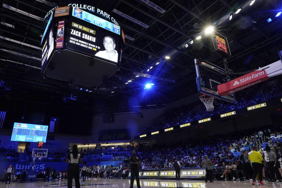 An image of Zack Shahin, who is being detained in the United Arab Emirates, is shown on the large video screen at College Park Center, during a timeout in the first half of a WNBA basketball game between the Phoenix Mercury and Dallas Wings, Wednesday, June 7, 2023, in Arlington, Texas. (AP Photo/Tony Gutierrez)