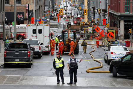Emergency personnel and workers are pictured at the scene of a gas leak in downtown Ottawa, Ontario, Canada, May 2, 2017. REUTERS/Chris Wattie