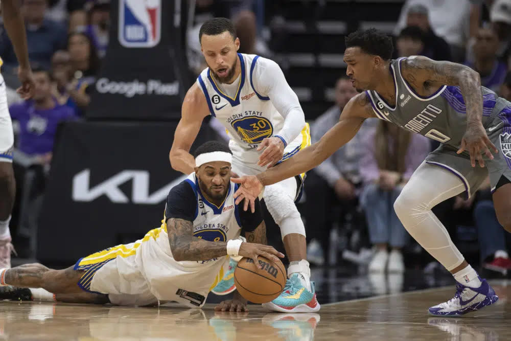 Golden State Warriors guard Gary Payton II dives after a loose ball between guard Stephen Curry (30) and Sacramento Kings guard Malik Monk (0) during the second half of Game 5 of an NBA basketball first-round playoff series Wednesday, April 26, 2023, in Sacramento, Calif. The Warriors won 123-116. (AP Photo/José Luis Villegas)