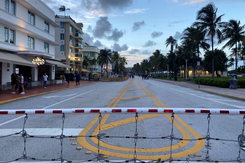 A barrier blocks a street after the 8 pm curfew in Miami Beach