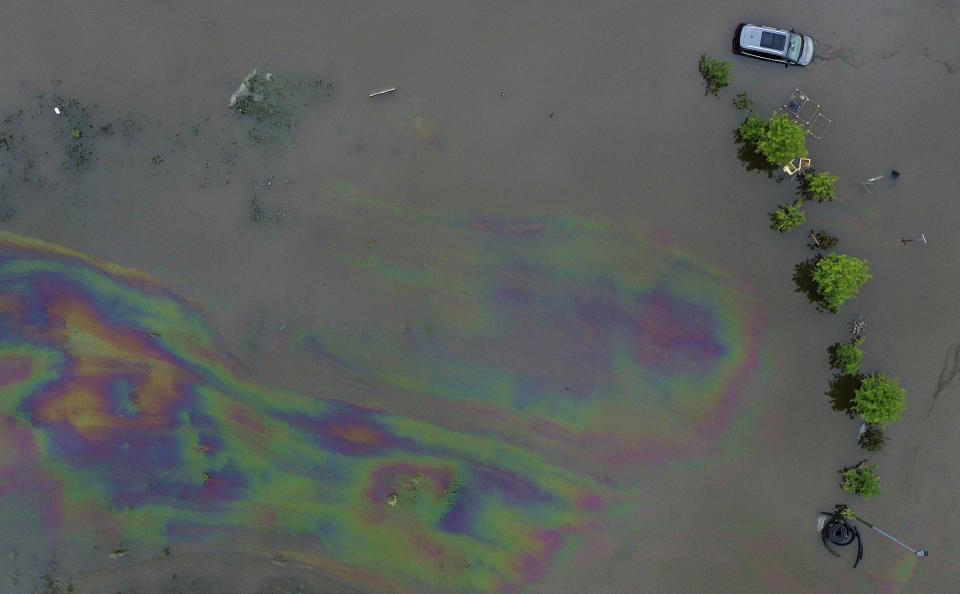 A view of an oil slick on a property flooded by water from the Mindel river, in Offingen, Germany, Monday, June 3, 2024. Persistent heavy rain led to widespread flooding in the southern states of Bavaria and Baden-Wuerttemberg over the weekend. (Karl-Josef Hildenbrand/dpa via AP)