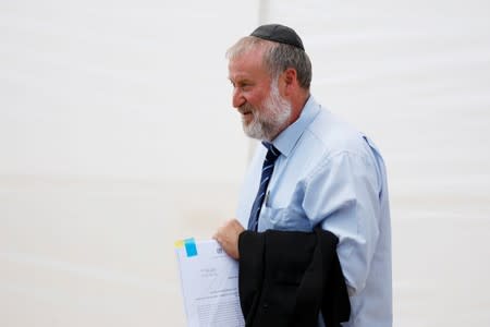 Israeli Attorney-General Avichai Mandelblit holds documents as he attends a weekly cabinet meeting in the Jordan Valley, in the Israeli-occupied West Bank