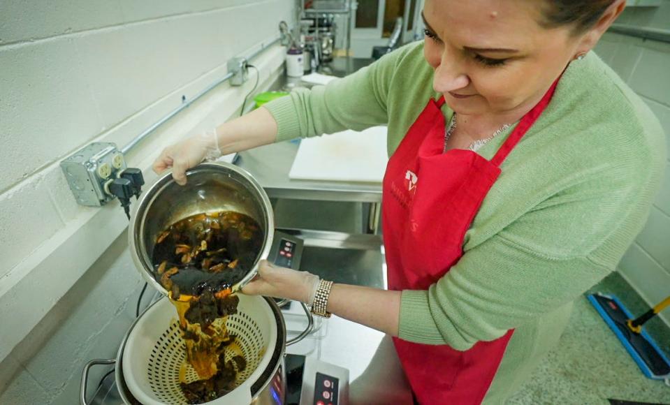 Wioletta Bartoszek pours reconstituted dried mushrooms and their soaking liquid into a soup pot while making mushroom soup at Wioletta's Polish Market, 3955 S. Howell Ave. Mushroom soup is one of 12 dishes traditionally served for Wigilia dinner, on Christmas Eve.