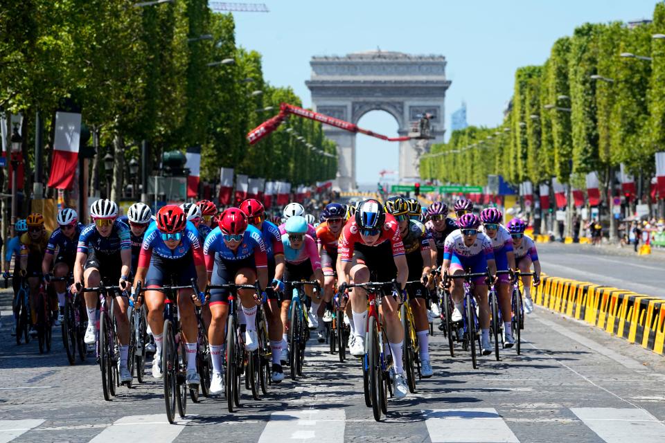 The pack speeds down the Champs Elysee (AP)