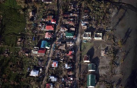 An aerial view shows damaged houses after strong winds and heavy rains brought on by Typhoon Hagupit battered Can-Avid municipality, Eastern Samar, central Philippines, in this December 9, 2014 handout picture courtesy of Philippine Air Force. REUTERS/Philippine Air Force/Handout via Reuters