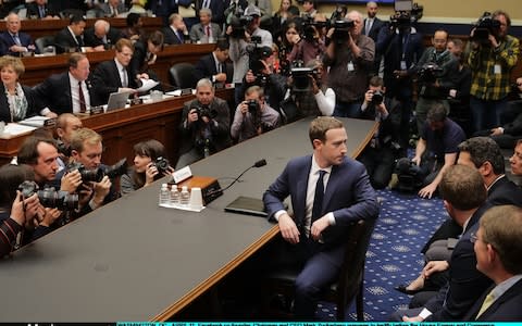 Mark Zuckerberg has a last minute conversation ahead of his questioning - Credit: Getty