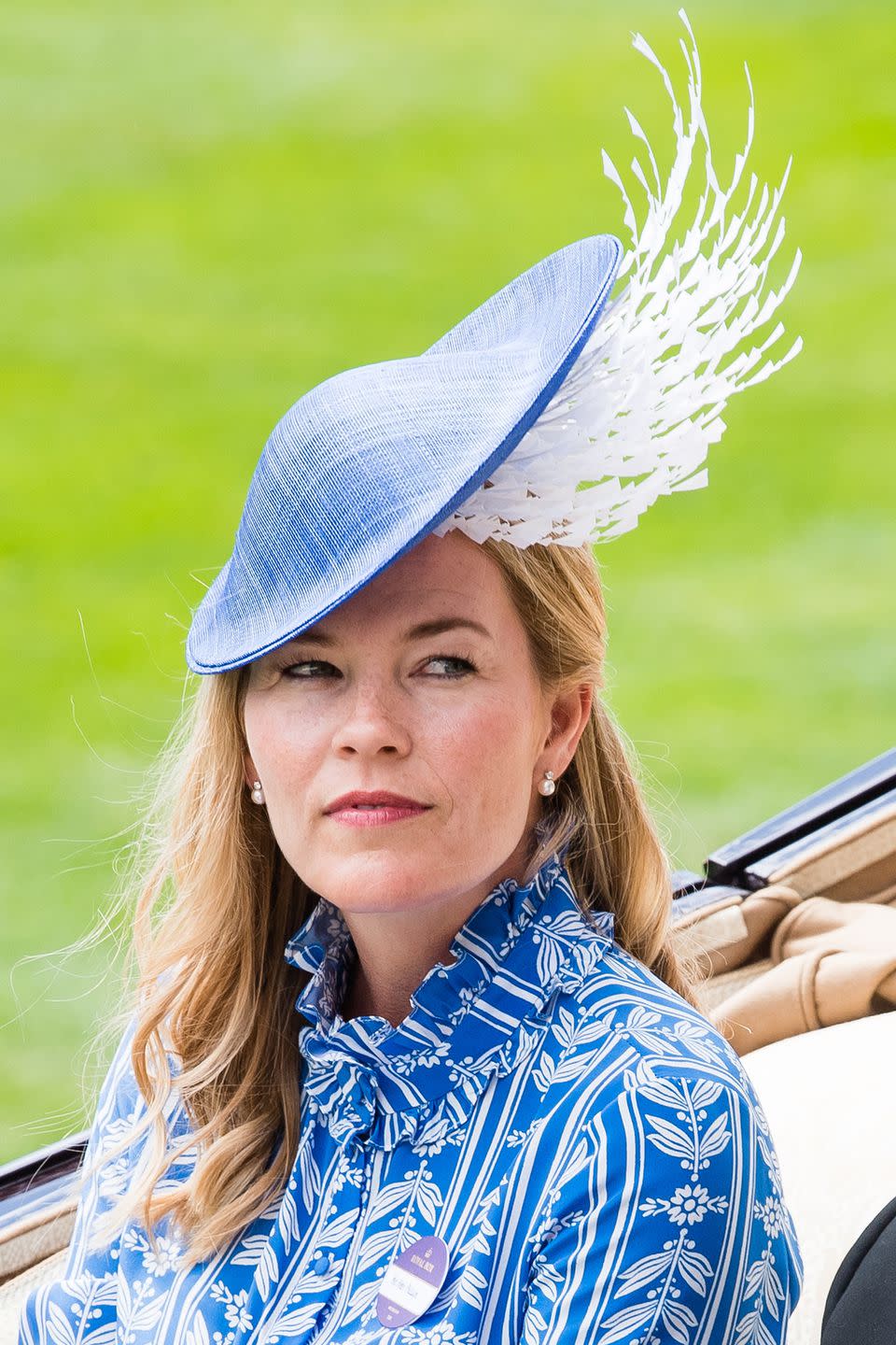 <p>Autumn Phillips (granddaughter of Queen Elizabeth II) arrived to the events in a baby blue and white feather cap.</p>