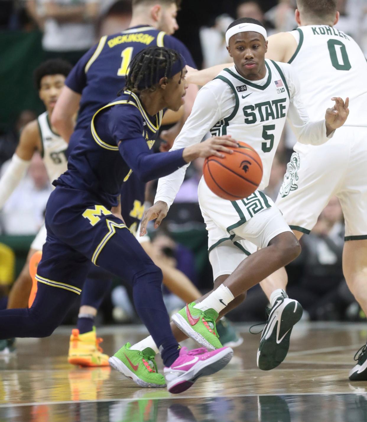 Michigan State guard Tre Holloman defends against Michigan guard Dug McDaniel during the second half of MSU's 59-53 win over U-M on Saturday, Jan. 7, 2023, at Breslin Center.