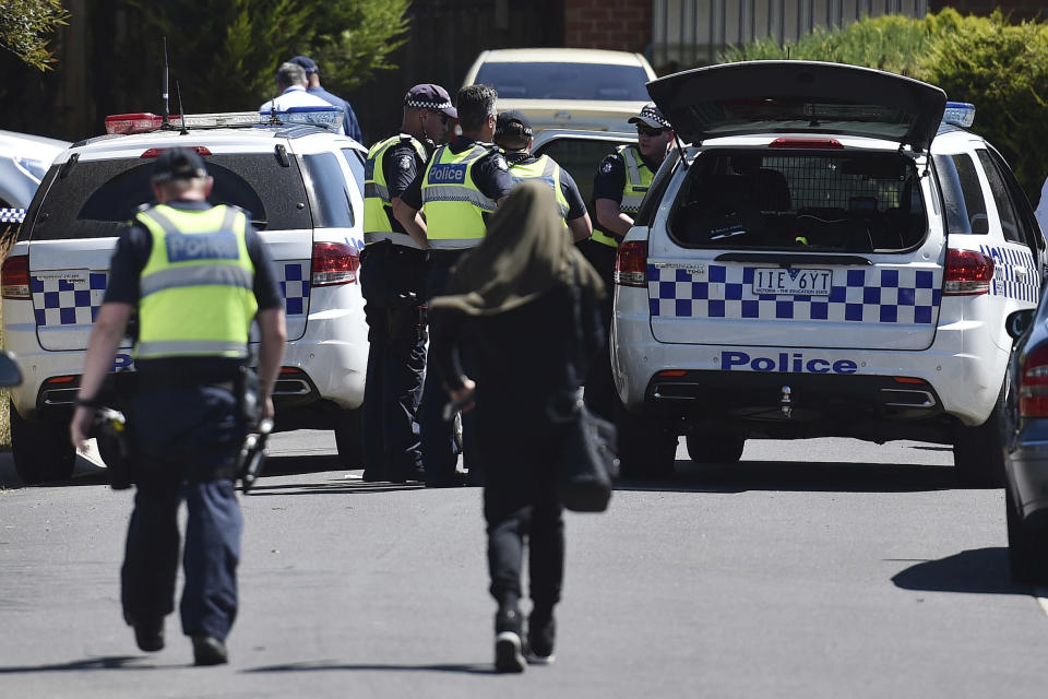 <p> Police accompany a woman as they attend the scene where a house was raided at Meadow Heights in Melbourne, Australia, Friday, Dec. 23, 2016. Police in Australia detained five suspects who were allegedly planning a series of Christmas Day bomb attacks in the heart of the country's second largest city, officials said Friday. (Julian Smith/AAP Image via AP) </p>