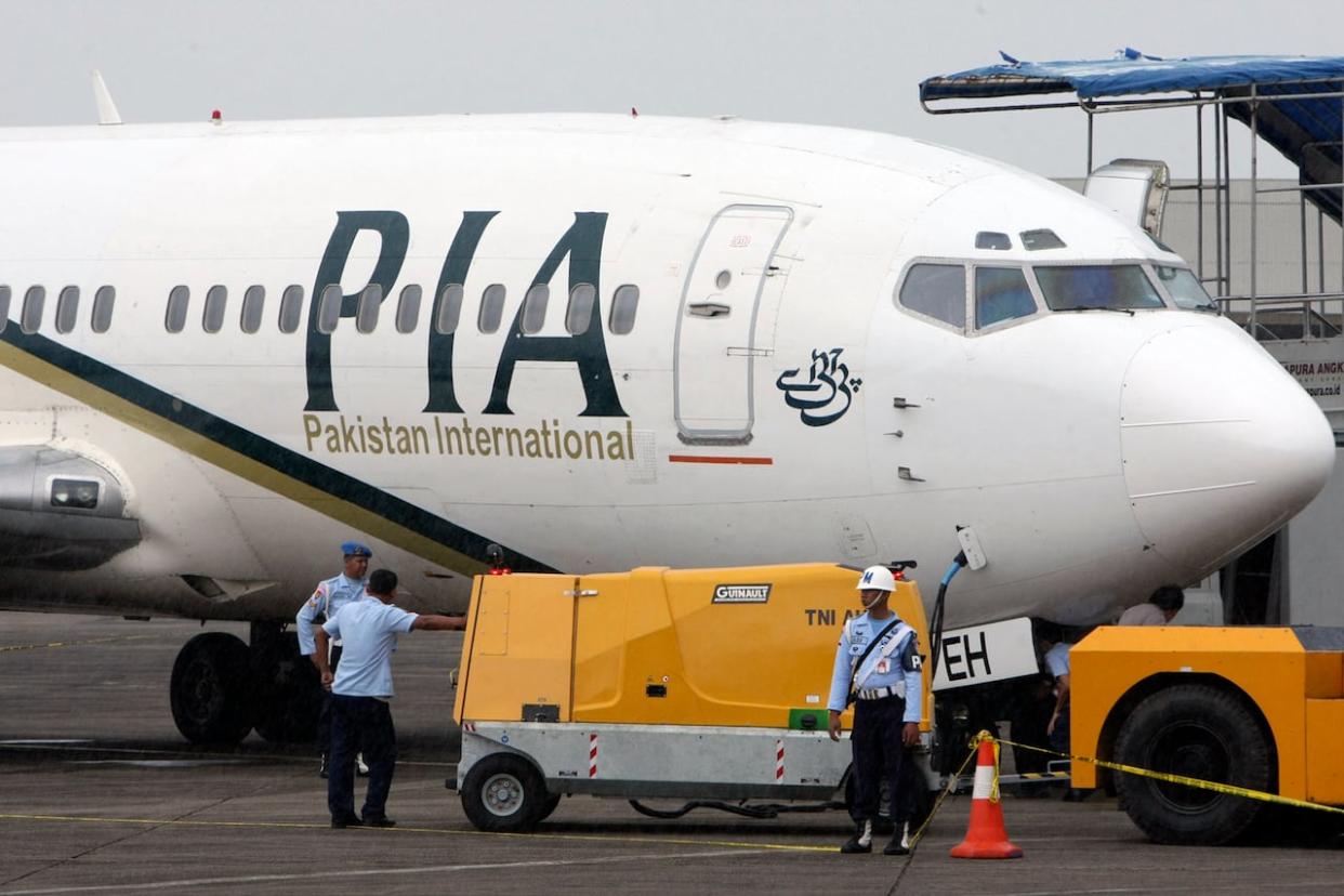 Pakistan International Airlines announced last month that it would be scaling back its operations as unpaid bills and overdue payments rack up.  (Associated Press - image credit)