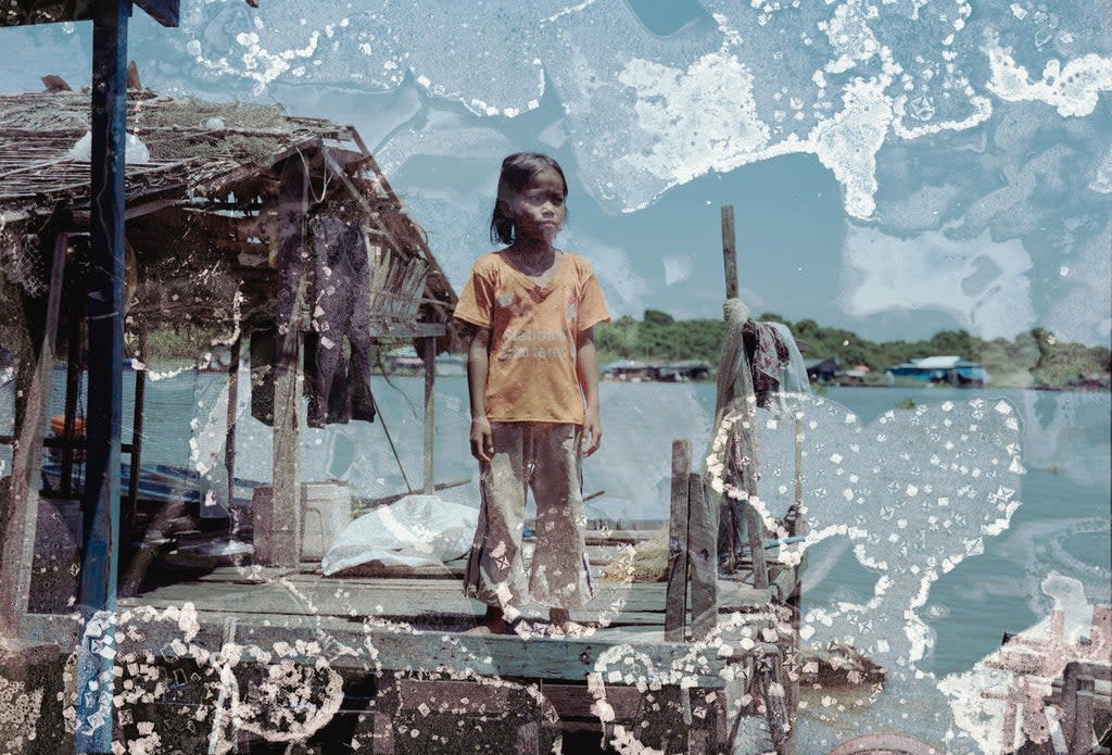 Mara, 9, standing on a fishing farm platform on Tonlé Sap lake in Cambodia (Lim Sokchanlina/Save the Children)