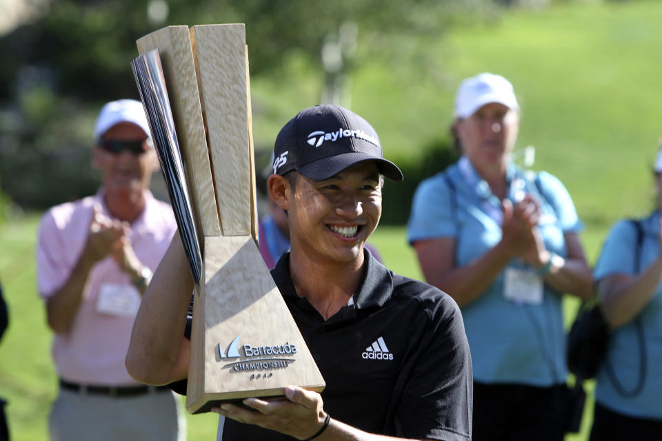 Collin Morikawa holds up his trophy for the gallery after winning the Barracuda Championship golf tournament at Montreux Golf & Country Club in Reno, Nev., Sunday, July 28, 2019. (AP Photo/ Lance Iversen)