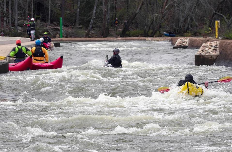 Kayakers paddle on the “paperclip” bypass on the Catawba River in Great Falls on March 19.