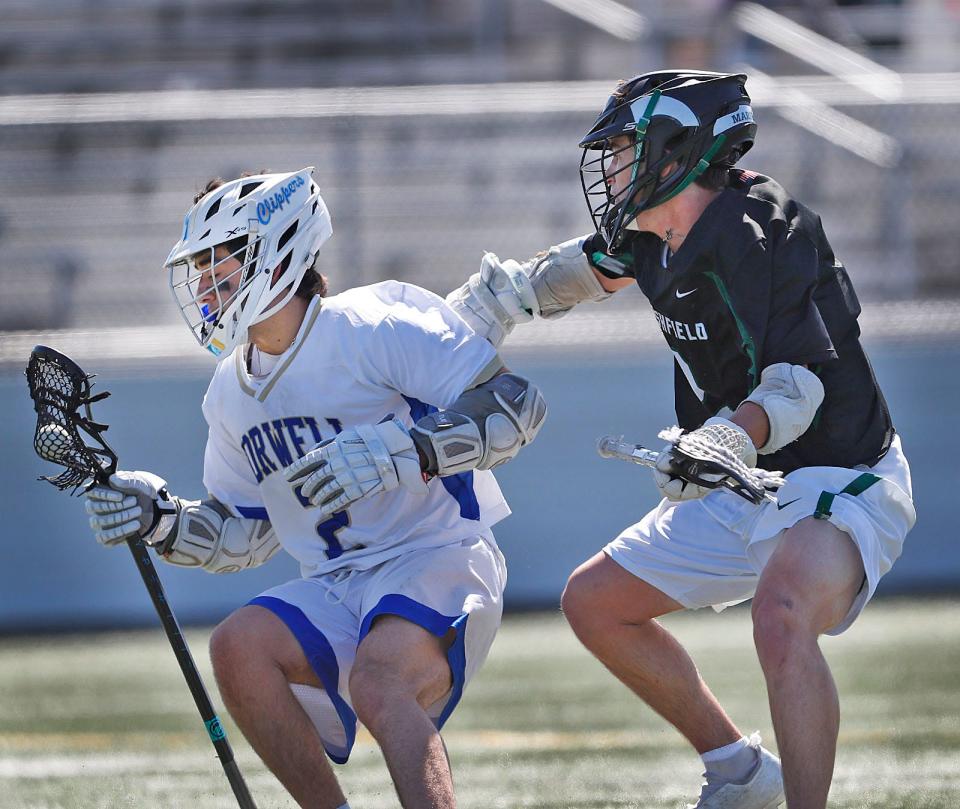 Nolan Petrucelli of Norwell and Nic Cupples of Marshfield mix it up in the midfield. Marshfield lacrosse hosted Norwell in the "Chowda Cup" semifinals on Thursday, April 20, 2023.