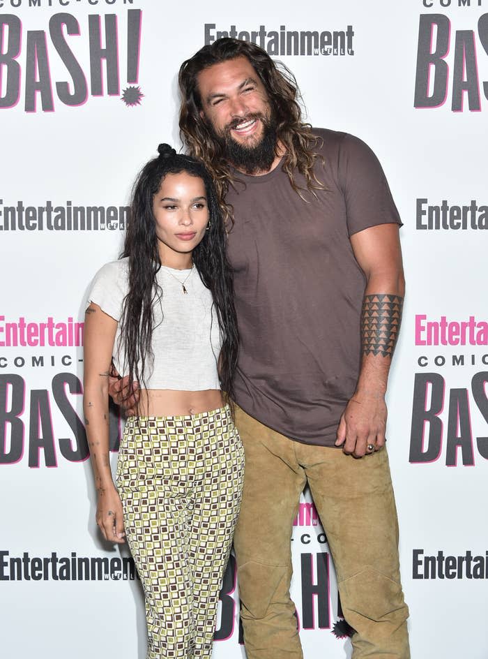 Zoë and Jason with their arms around each other as they pose for photographers at a red carpet event