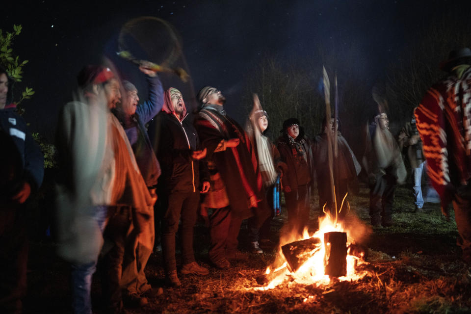 Mapuche people gather around a campfire to mark We Tripantu, the Mapuche new year, in the Corayen community of Los Rios, southern Chile, on Tuesday, June 21, 2022. We Tripantu is one of the most sacred holidays for the Mapuche, Chile's largest Indigenous group. (AP Photo/Rodrigo Abd)