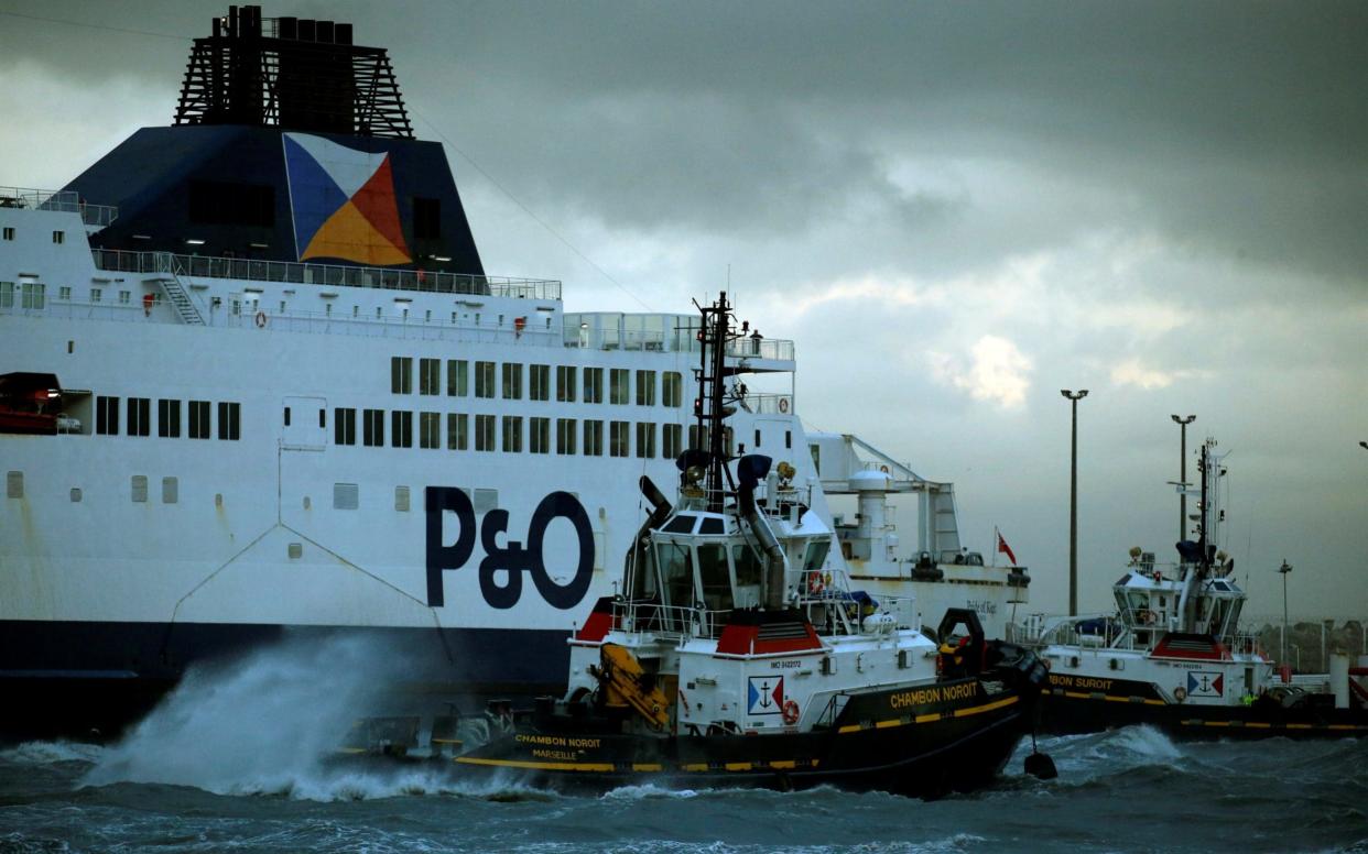 A tugboat manoeuvres the P&O ferry Pride of Kent after it ran aground during bad weather in the port of Calais - REUTERS