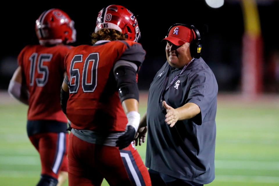 Carl Albert coach Mike Dunn celebrates after a touchdown against Midwest City on Sept. 2.