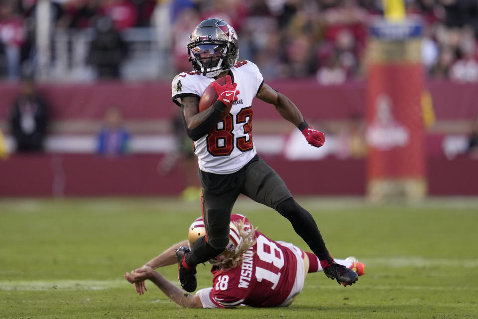 Tampa Bay Buccaneers' Deven Thompkins (83) returns a punt past San Francisco 49ers punter Mitch Wishnowsky (18) during the second half of an NFL football game in Santa Clara, Calif., Sunday, Nov. 19, 2023. (AP Photo/Godofredo A. Vásquez)